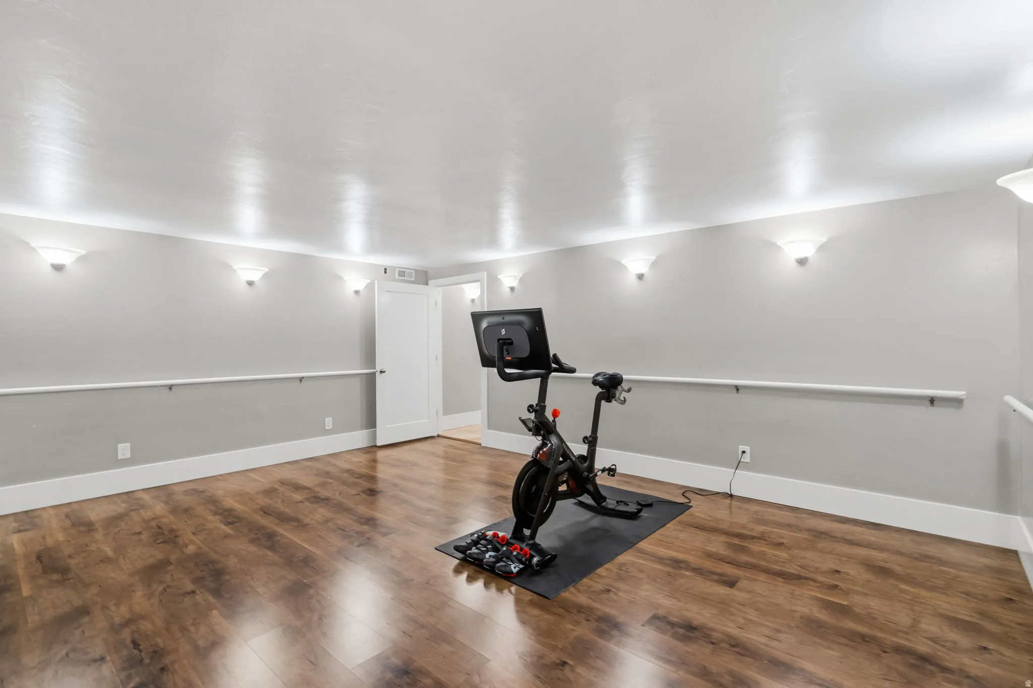 Ballet barres along three walls make this an incredible dance studio, while the spacious layout easily accomodates a home gym or workout space.