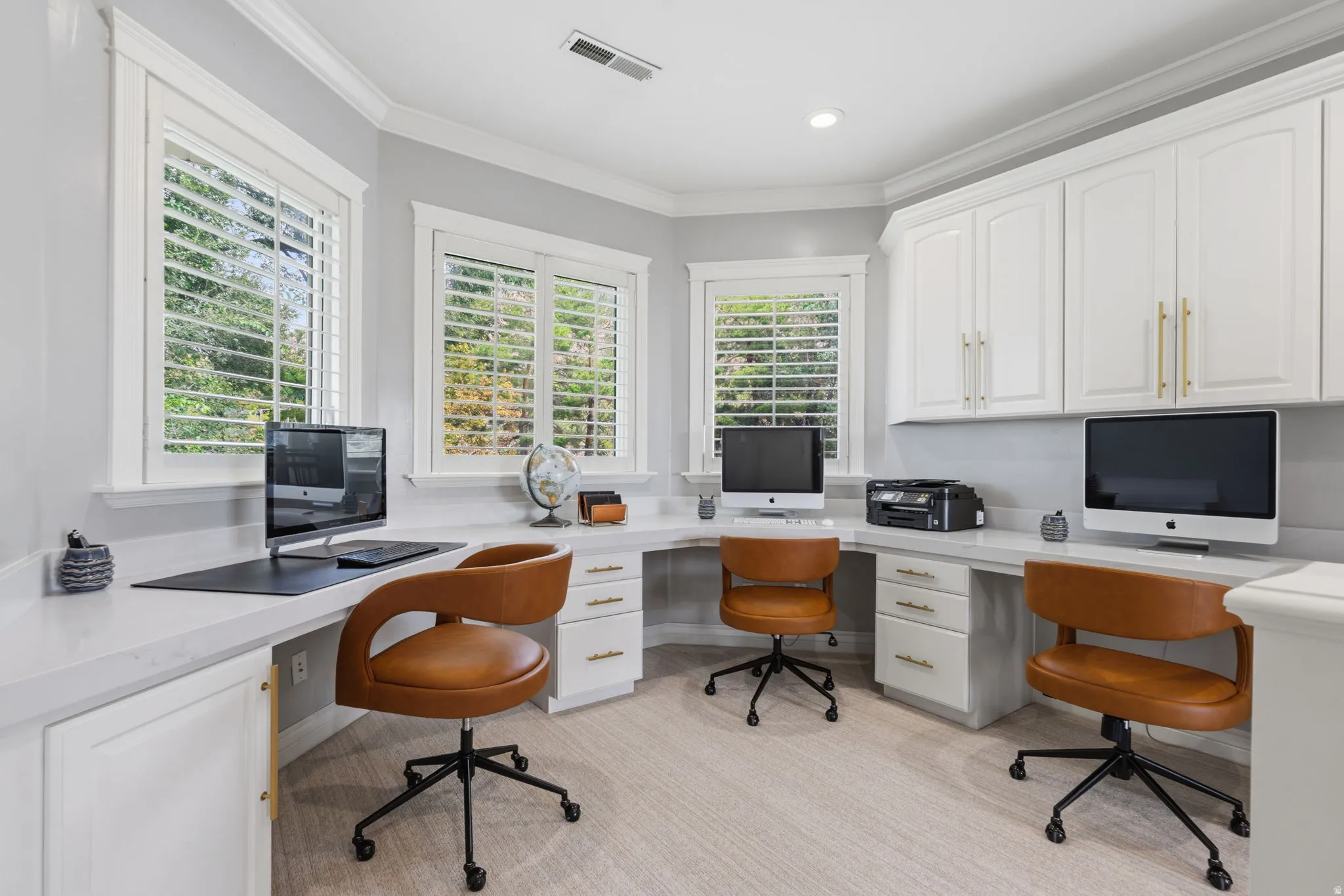 Open upstairs Homework Center features three built-in workstations, each with dedicated drawers, cabinetry, and space for a computer.