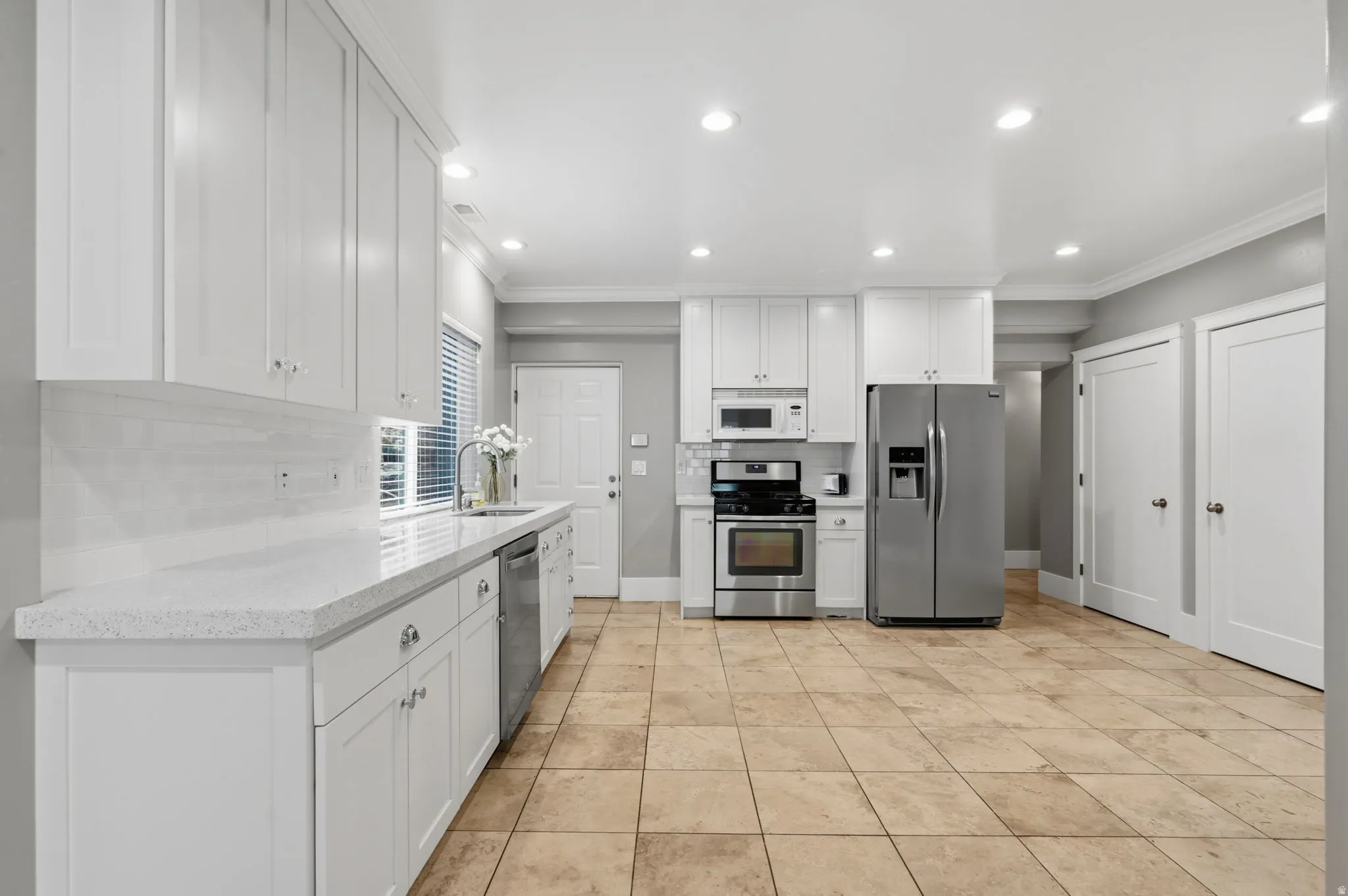 Full second kitchen with abundant cabinetry full-size refrigerator, range, and plenty of room for a dining table.