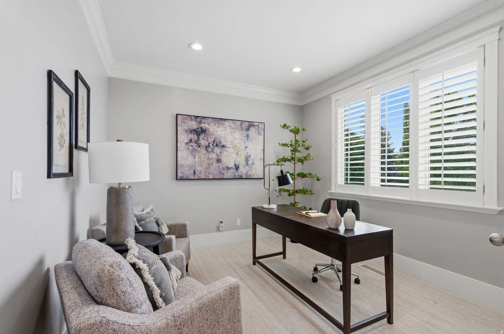 Bright, spacious office with room for a full desk and comfortable client seating, plus a large window creating an open, airy feel