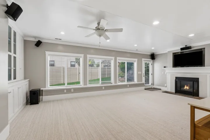 Spacious, light-filled basement great room with 3 large windows, 9-foot ceilings, and direct access to the side yard.