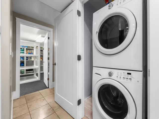 Dedicated stackable washer and dryer provide convenient in-unit laundry for the lower level.