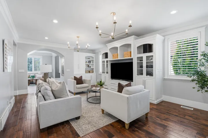 Custom built-ins offer space for the TV and electronics, decorative display areas, hidden storage, and a favorite feature--a large pull-out drawer perfect for keeping blankets tucked neatly out of sight!