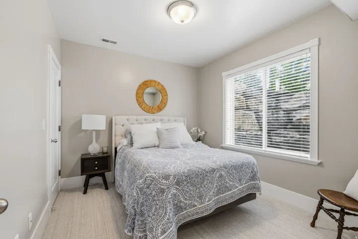 Bedroom #5--Bright, good sized bedroom with 9-foot ceilings, a large window with an expanded rock window well, and small walk-in closet