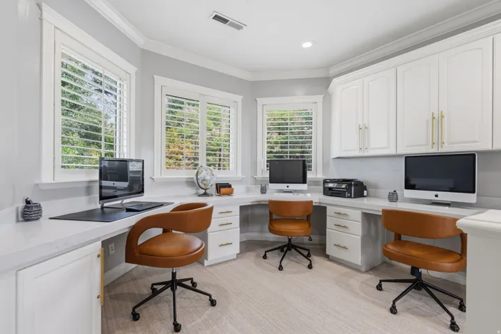 Open upstairs Homework Center features three built-in workstations, each with dedicated drawers, cabinetry, and space for a computer.