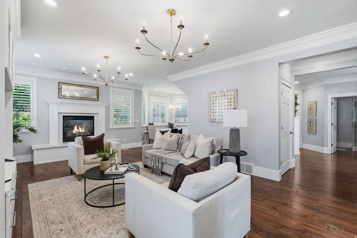 Large fireplace with raised hearth provides a cozy focal point and extra seating for family and guests.
