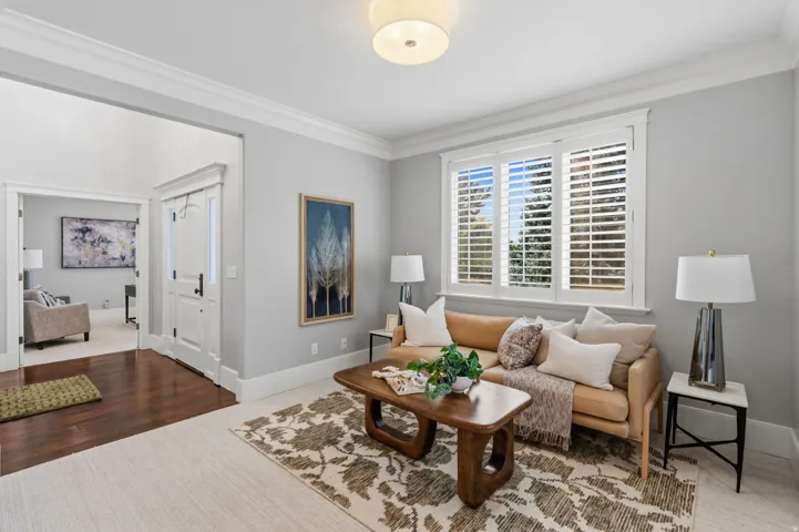Crown molding, recessed lighting, wood-finish flooring, white window shutters, and white trim