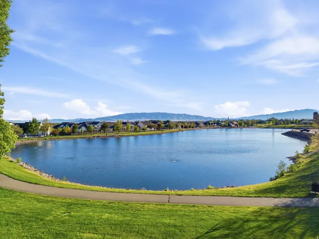 Expansive lakefront setting with a paved walking path and lush green grass just outside the gated neighborhood.  Such a fun place for kids to play and feed ducks!