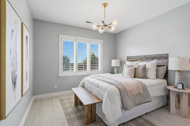 Bedroom #3 --Spacious light filled  bedroom with 9-foot ceilings, a beautiful chandelier, and a large window.  Bedrooms 3 & 4 each enjoy their own private vanity area while sharing the enclosed  tub/shower and toilet room.