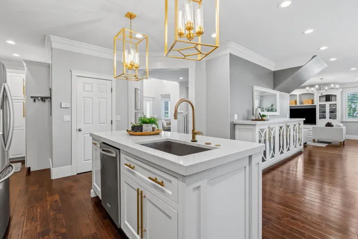 Large Island features an oversized single basi sink, dishwasher, and convenient pull-out trash cabinet