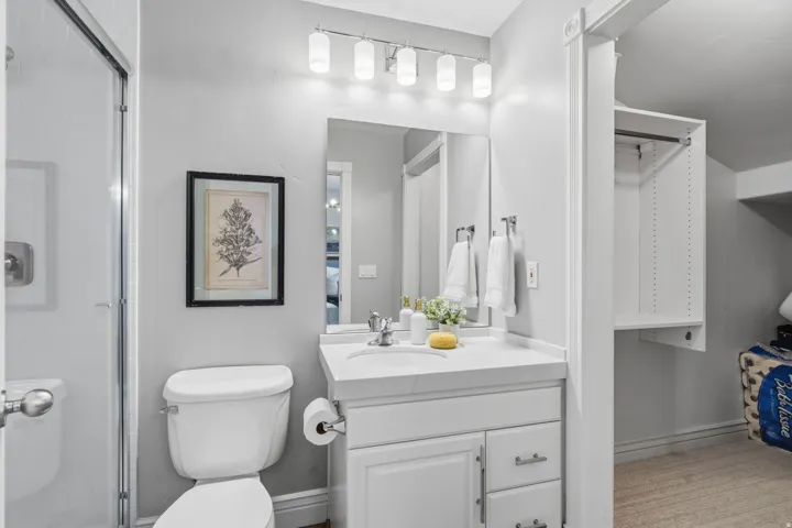 Bedroom #2 Private en suite-featuring a walk-in closet offers built-in drawers, hanging space, open shelving, plus a tucked-away bonus nook-perfect for extra storage or a fun little reading hideaway.