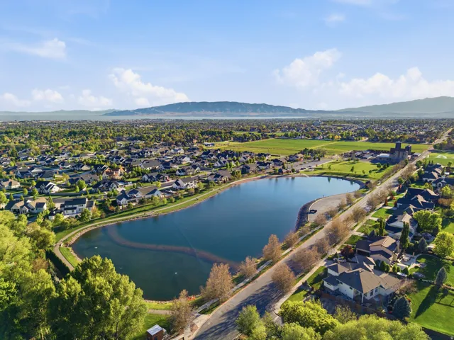 Aerial perspective showcasing the Manila Pond.  Great for fishing, swimming, canoeing, paddleboarding, feeding ducks, exercising on the paved side walk surrounding the pond.  Covered Pavillions, sandy beach and grass areas.