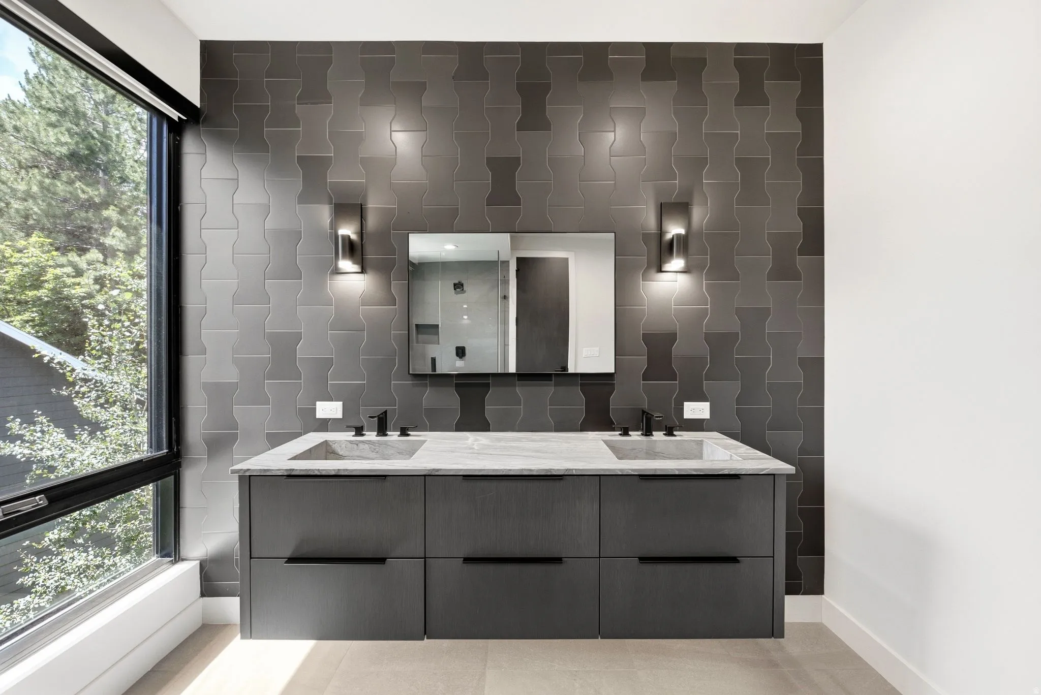 Dual vanity featuring a stone countertop, integrated sinks, and matte black fixtures