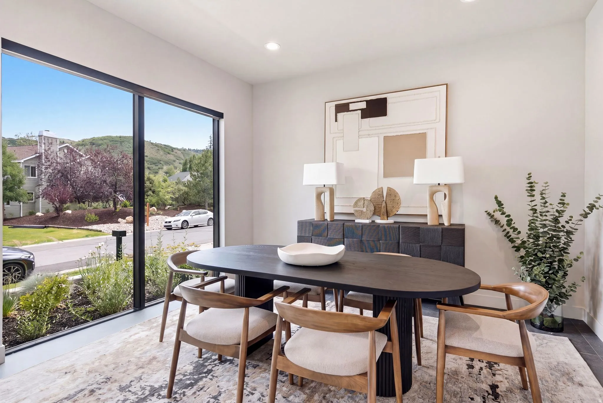 Dining area featuring a full-height window, recessed lighting, and light-toned walls