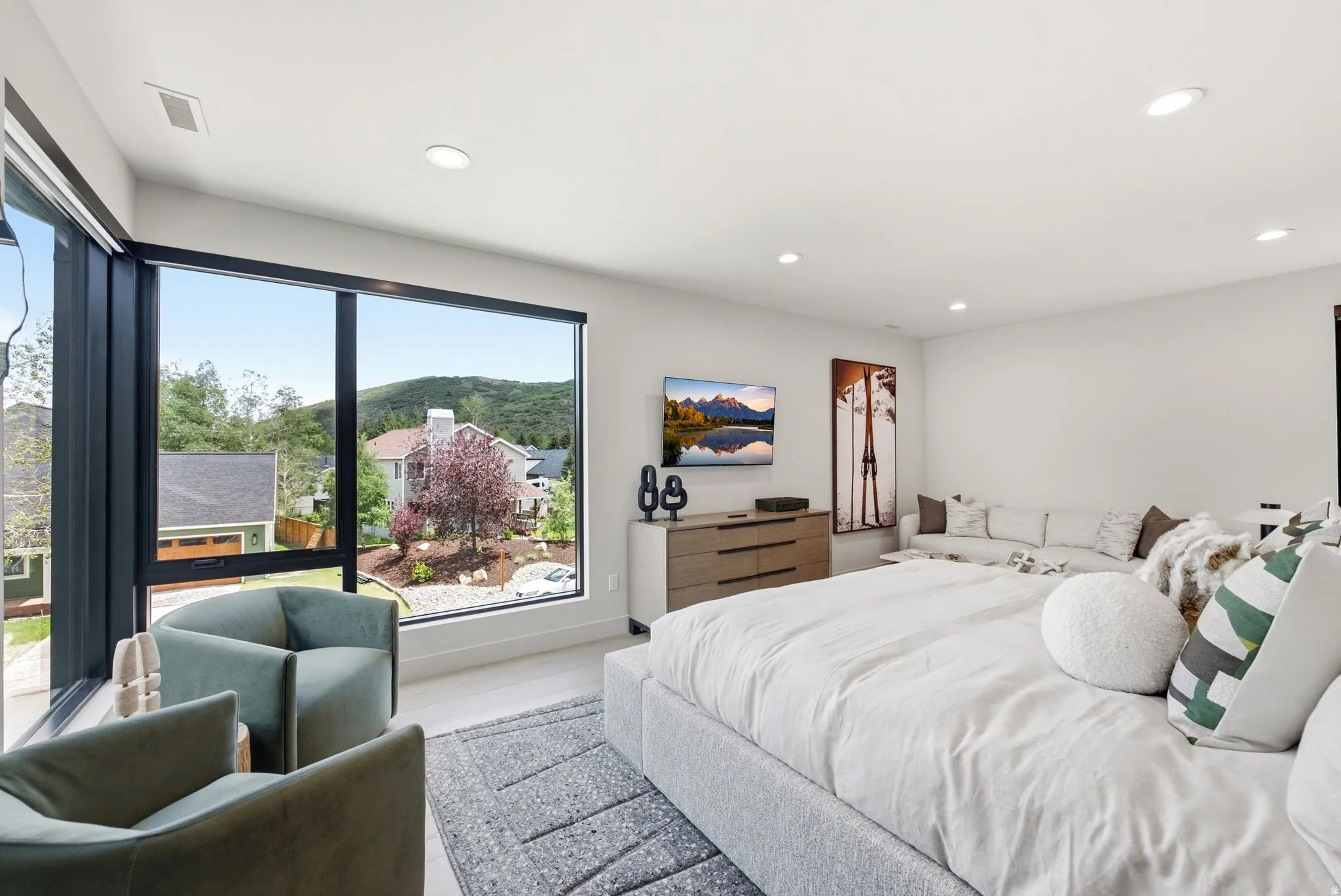 Expansive floor-to-ceiling windows featuring black frames and roller shades