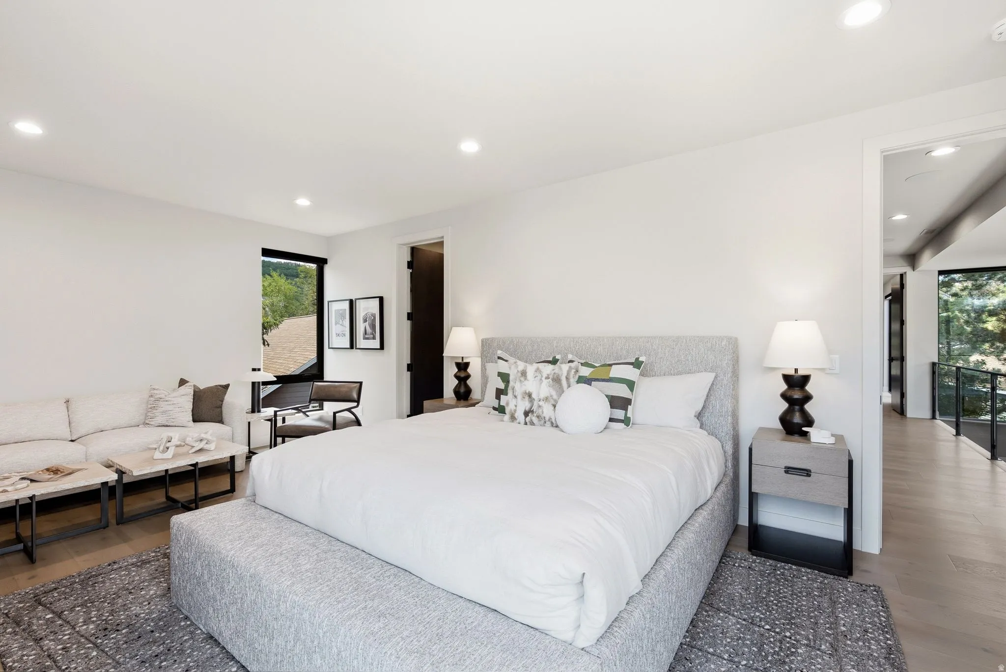 Spacious room featuring wood-finish flooring, recessed lighting, and a large window with black framing