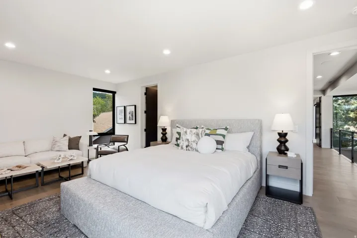 Spacious room featuring wood-finish flooring, recessed lighting, and a large window with black framing