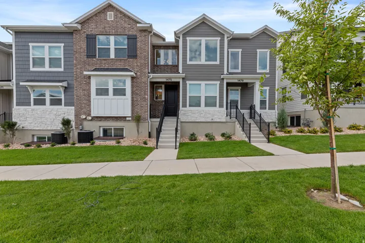 Contemporary townhouse exterior featuring brick and siding accents