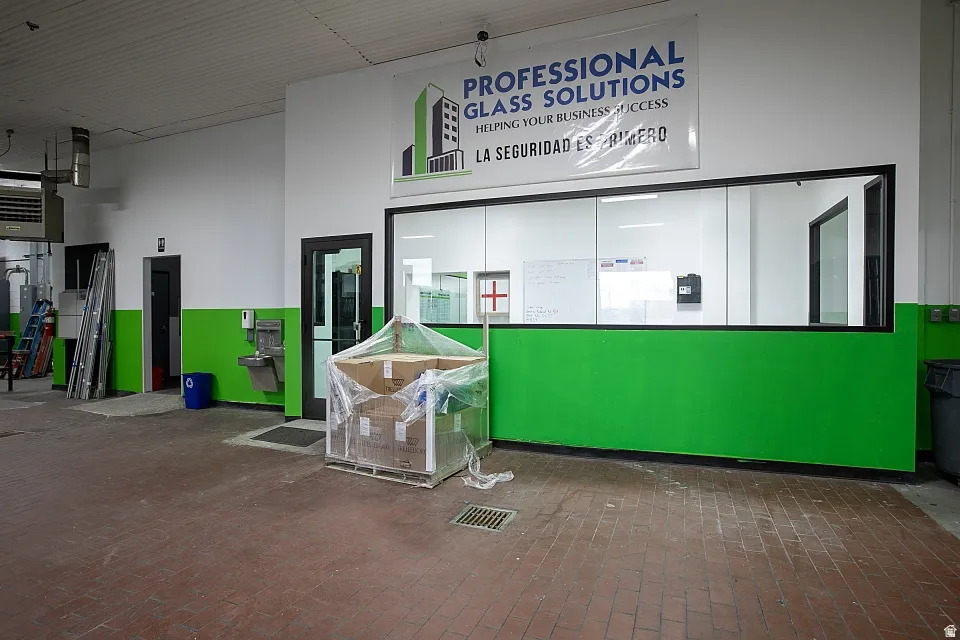 Industrial-style flooring with a glass-enclosed office area