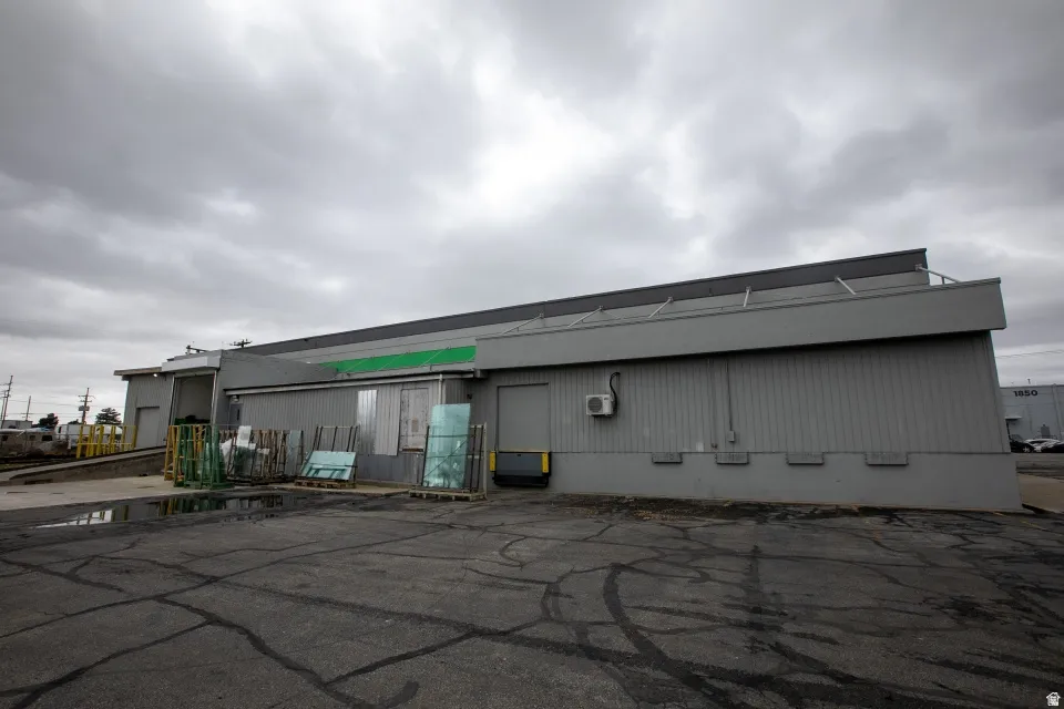 Commercial building featuring a loading dock with a ramp, a second loading bay, and a flat roofline
