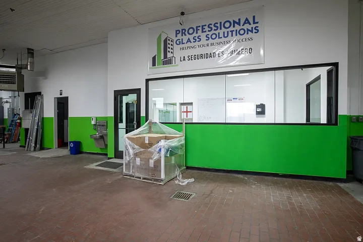 Industrial-style flooring with a glass-enclosed office area