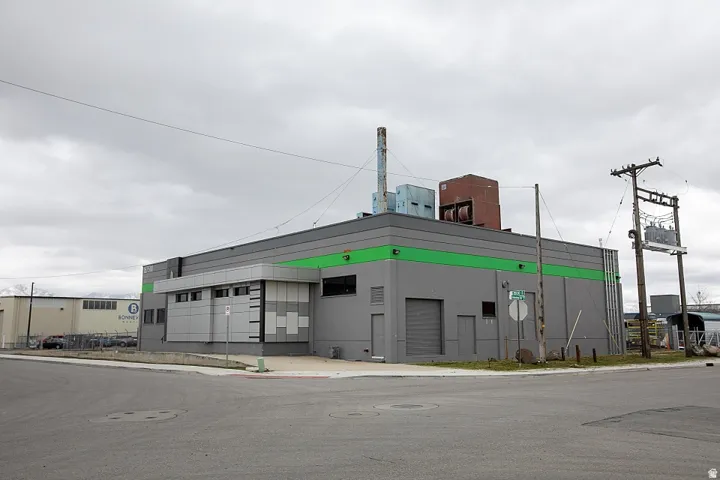 Commercial building with a grey facade and a green accent band