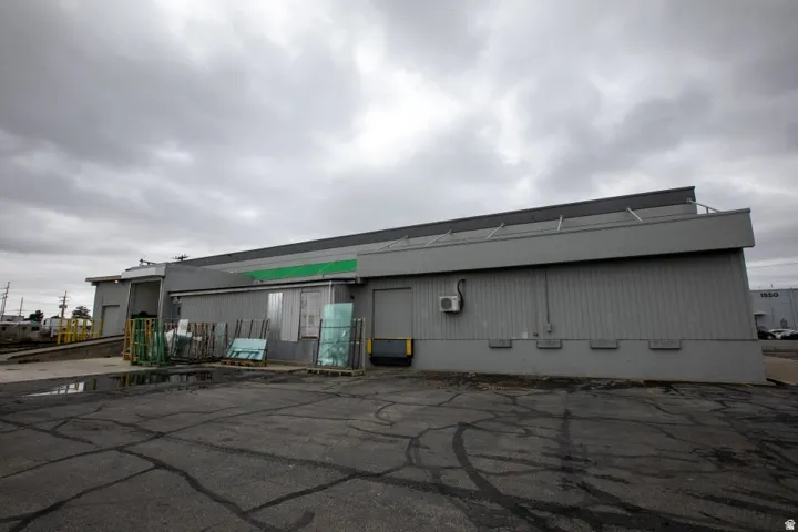 Commercial building featuring a loading dock with a ramp, a second loading bay, and a flat roofline