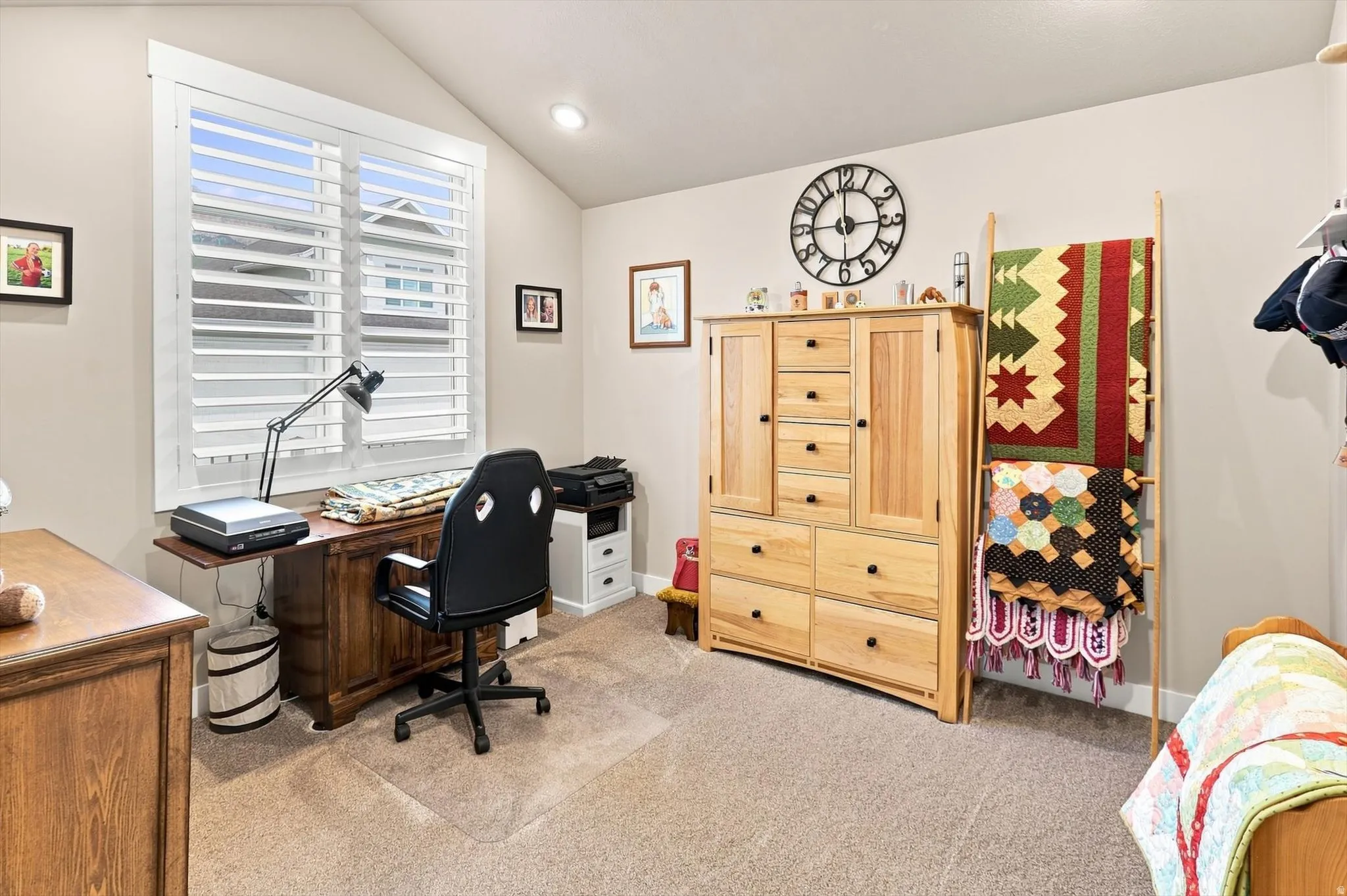 Interior room featuring vaulted ceilings, neutral wall paint, and carpeted flooring