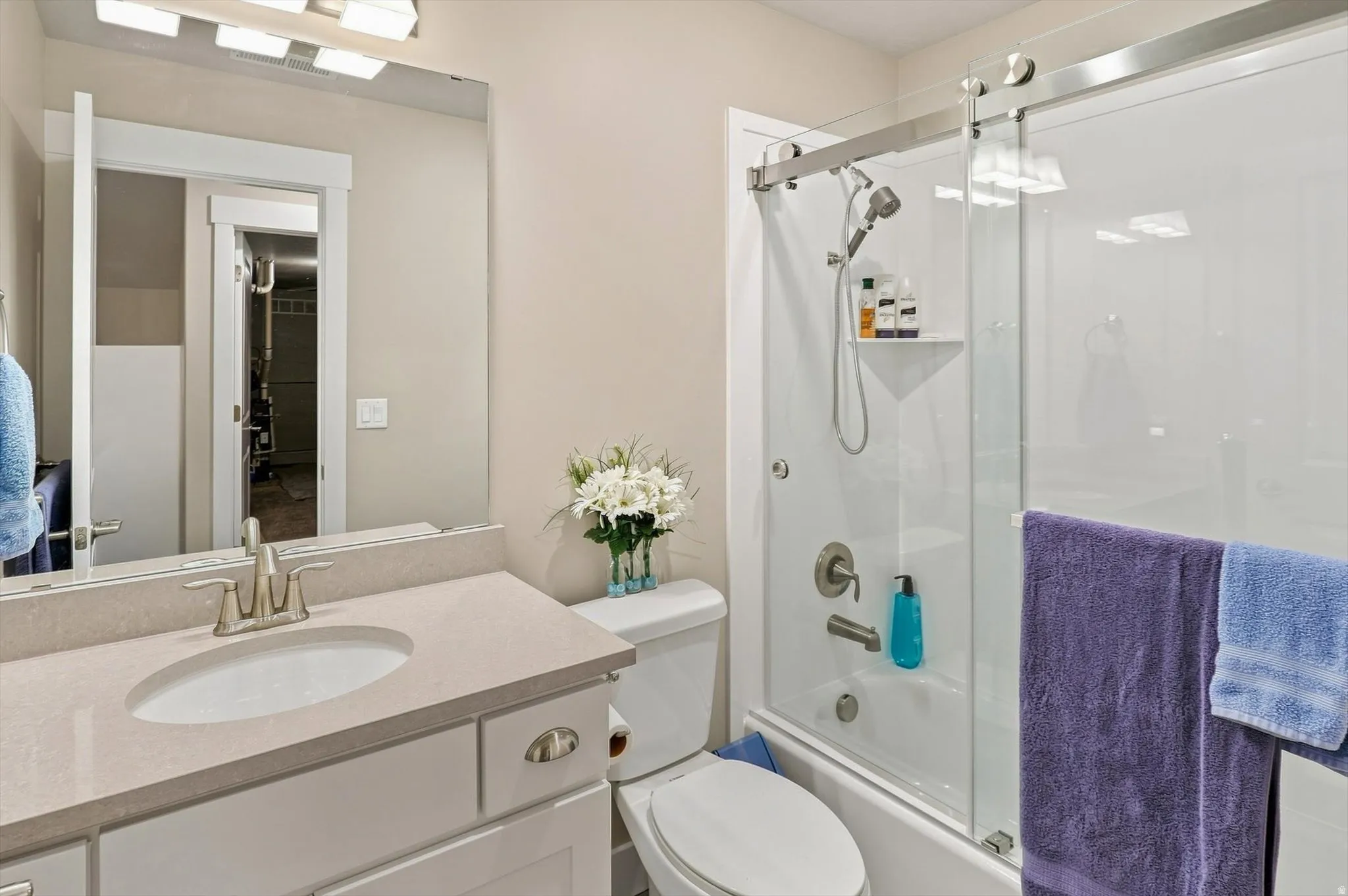 Vanity with an integrated sink and light-colored countertop