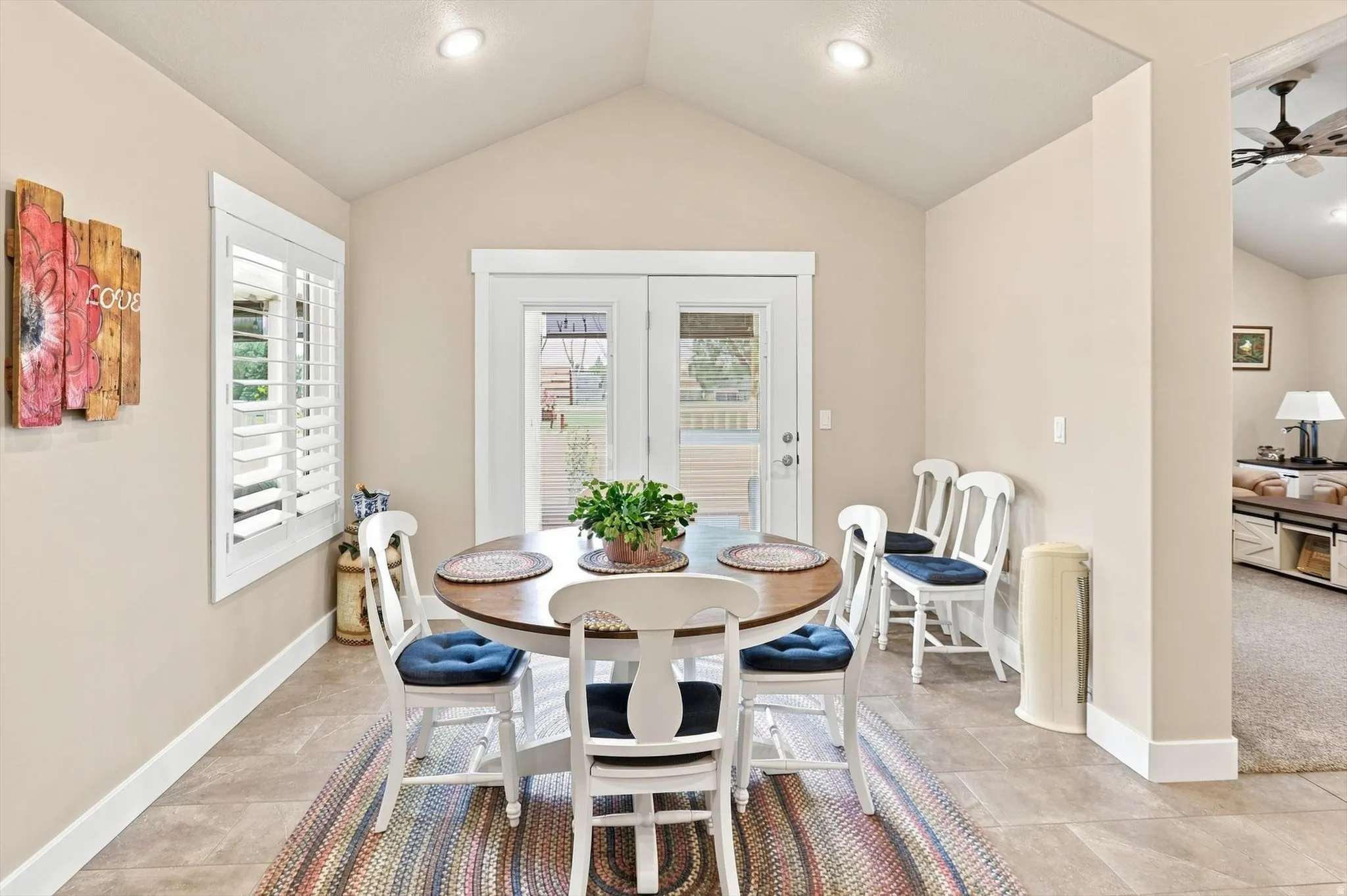Dining area featuring vaulted ceilings, recessed lighting, and tile flooring