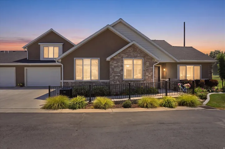 Contemporary exterior featuring stone veneer accents and stucco siding