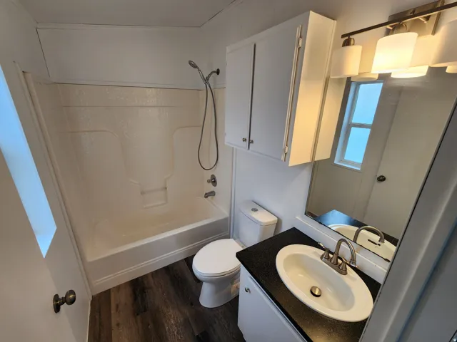 Bathroom featuring a combination bathtub and shower with a handheld showerhead