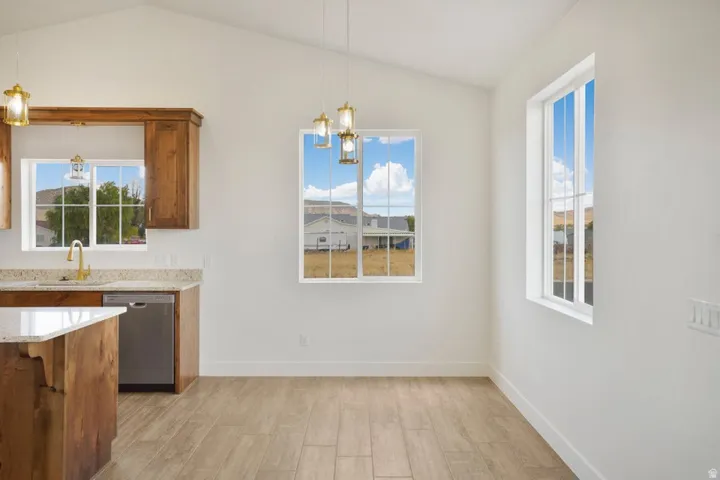 Vaulted ceilings featuring recessed lighting and pendant fixtures