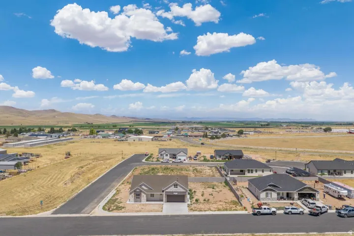 Newly constructed single-story residence featuring an attached two-car garage and a paved driveway