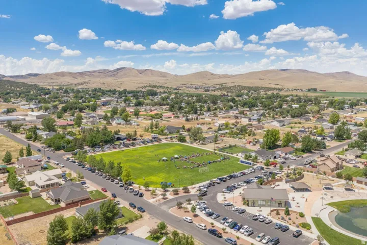 Aerial perspective showcasing a residential community with surrounding mountains