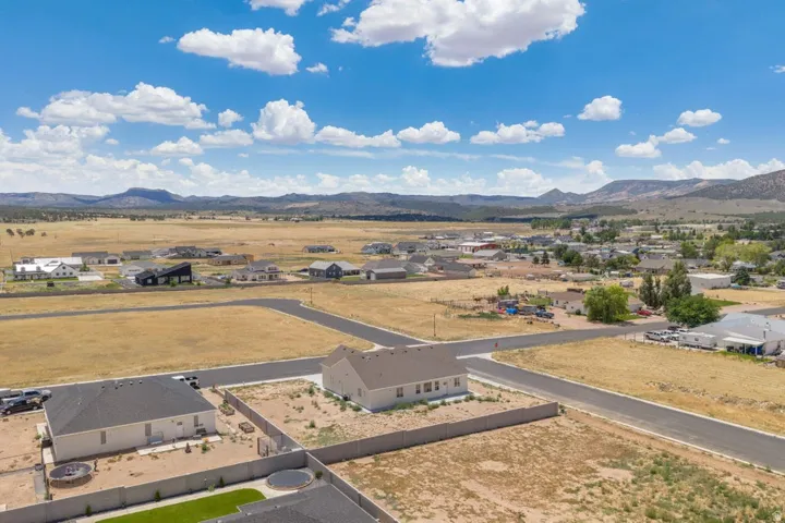 Expansive land parcel featuring paved roads and distant mountain scenery