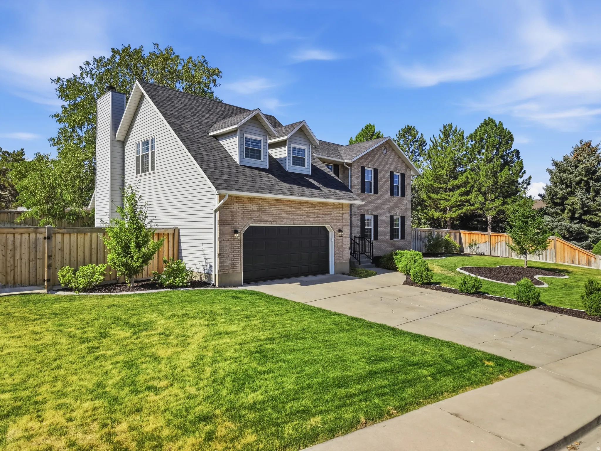 Traditional two-story residence featuring brick and siding exteriors