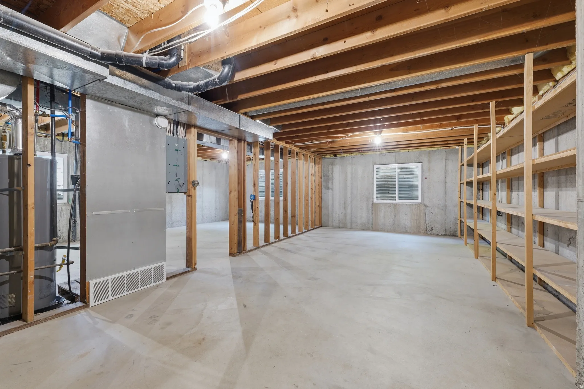 Expansive unfinished basement with shelving