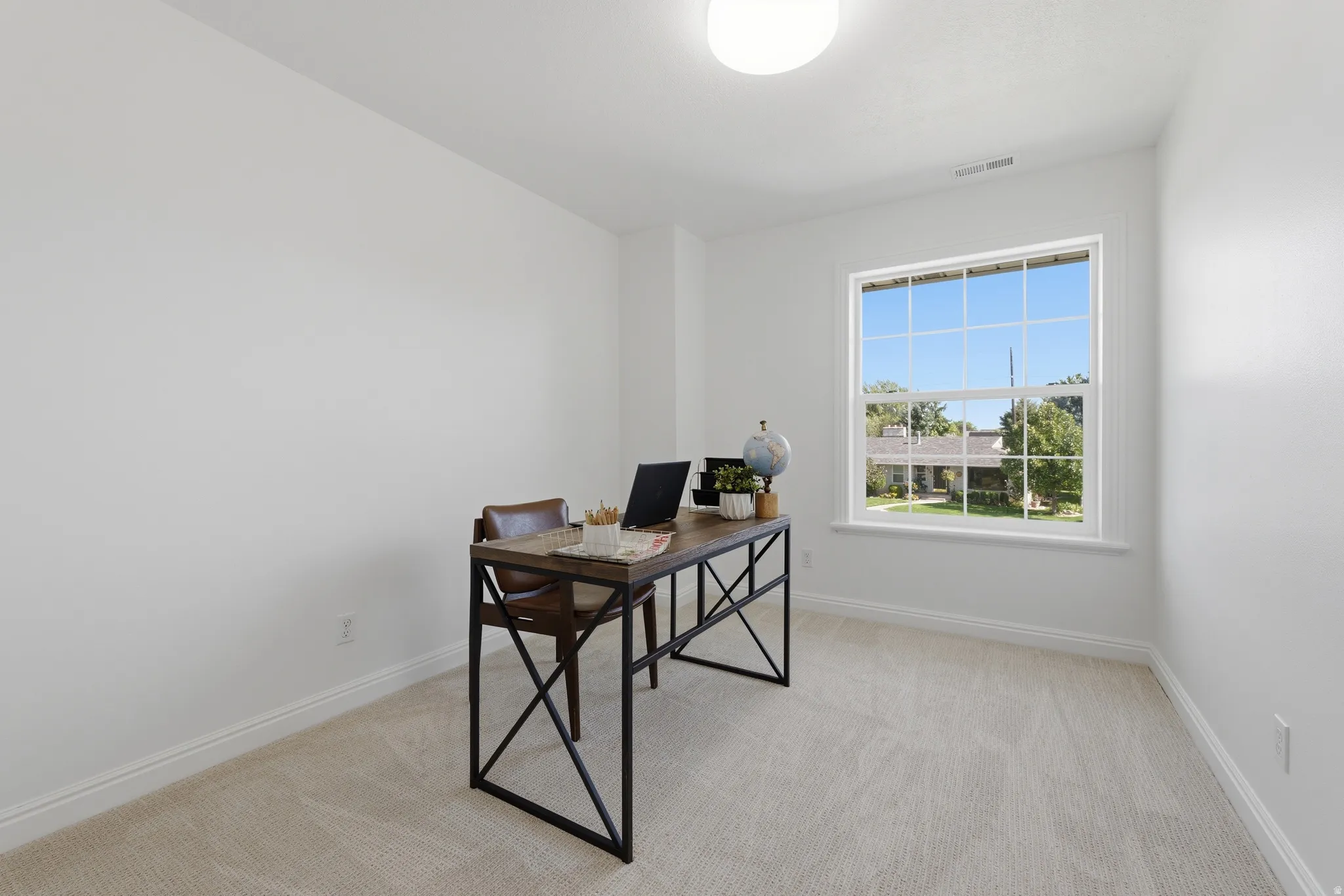 Bedroom 2 (staged as an office) with beautiful mountain views.