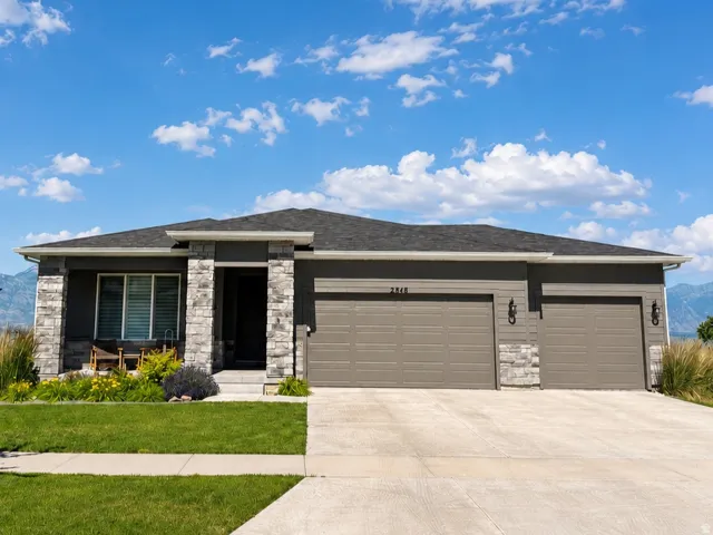 Contemporary single-story lakefront residence with a stone and siding facade