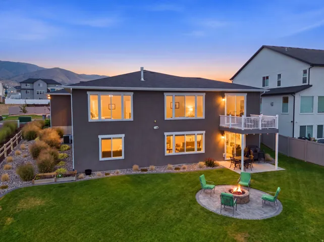 Manicured lawn with a paver patio and built-in fire pit