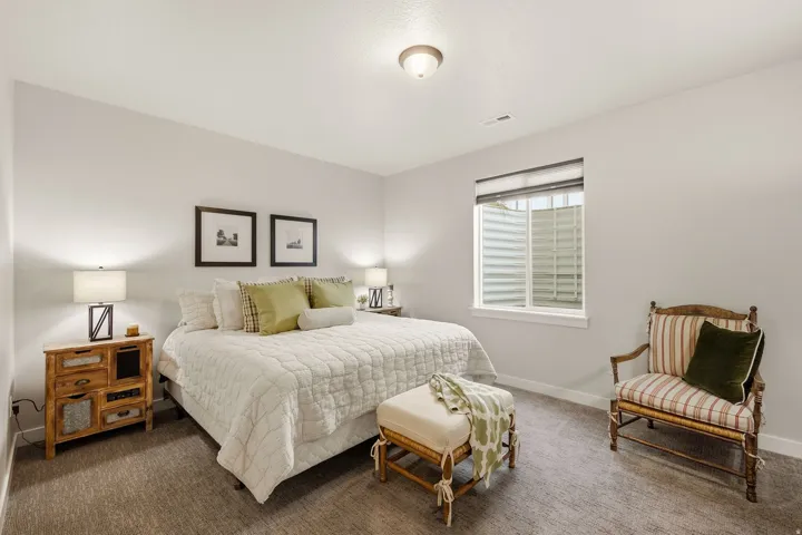 Neutral-toned wall paint, recessed window with blinds, and textured carpeting