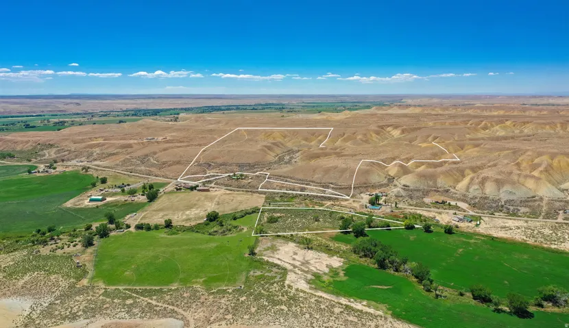 Expansive acreage featuring both verdant green fields and desert terrain