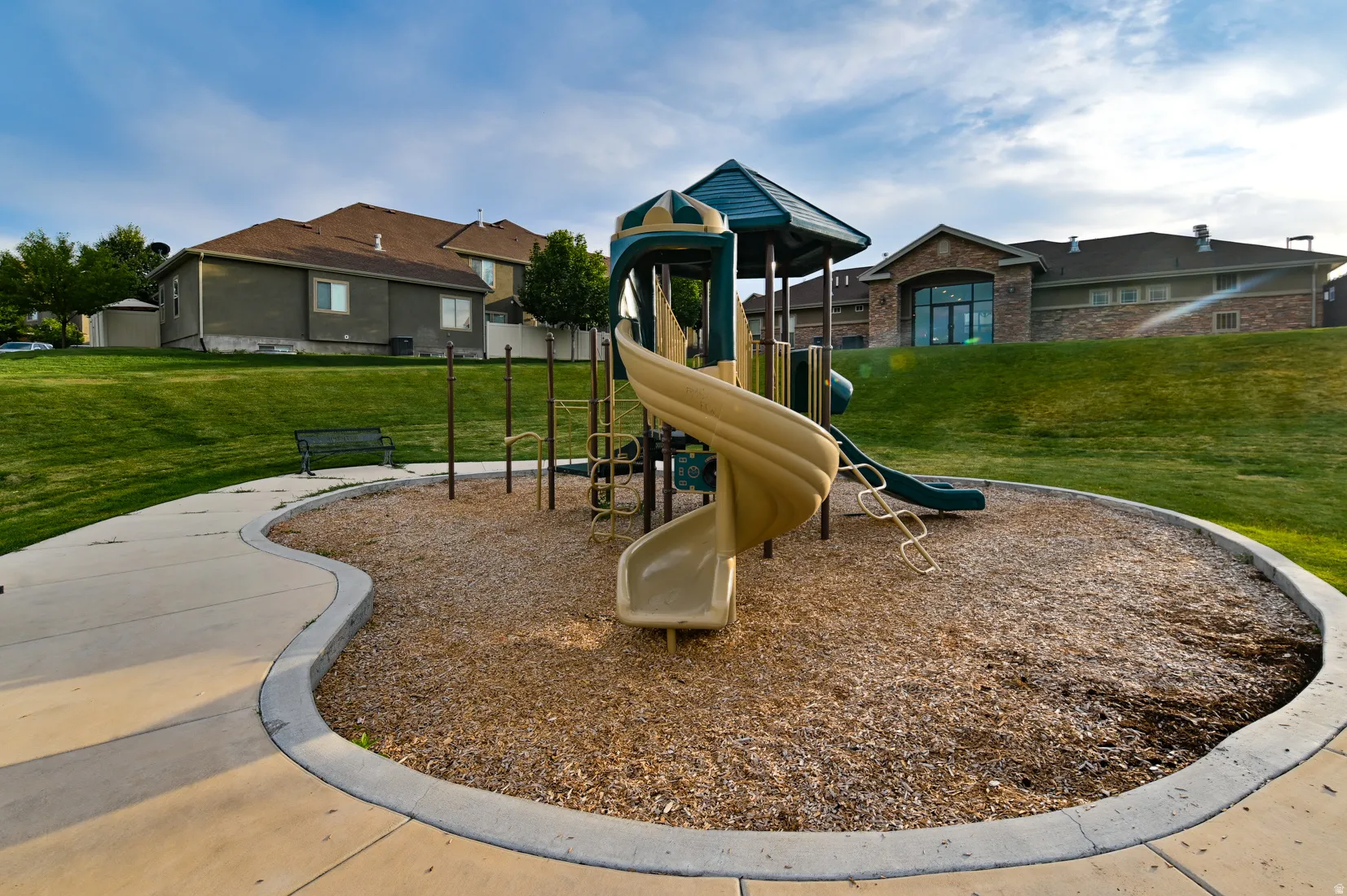 Dedicated playground area featuring a multi-level play structure with slides and climbing elements