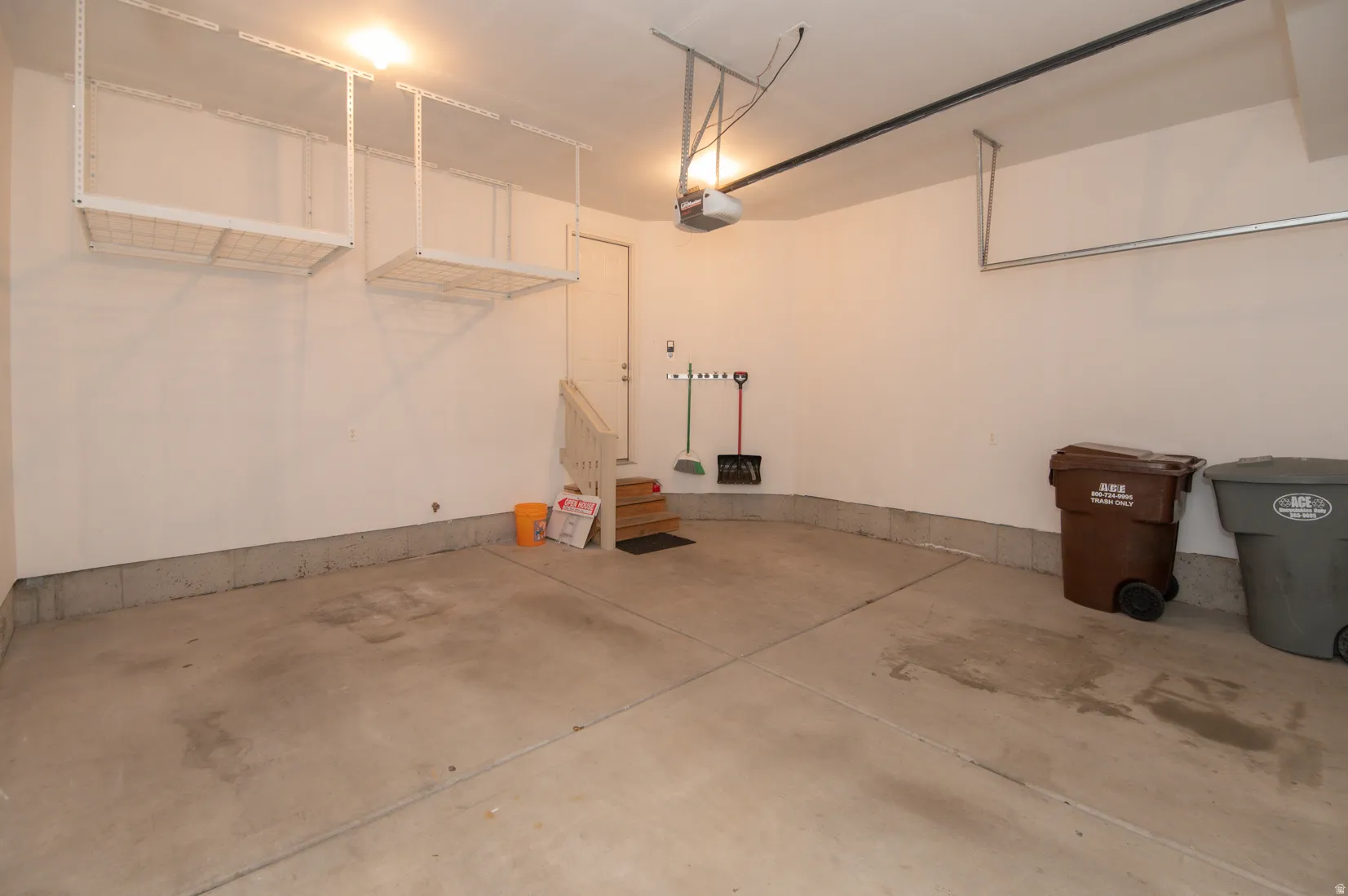 Spacious garage featuring concrete flooring and white painted walls