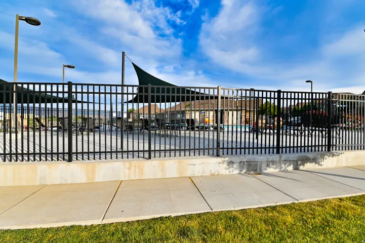 Fenced community pool area with partial shade coverings