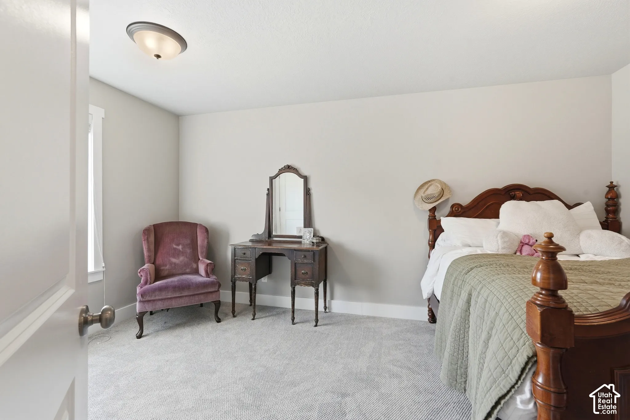 Neutral wall paint colors complement the light-toned carpeting