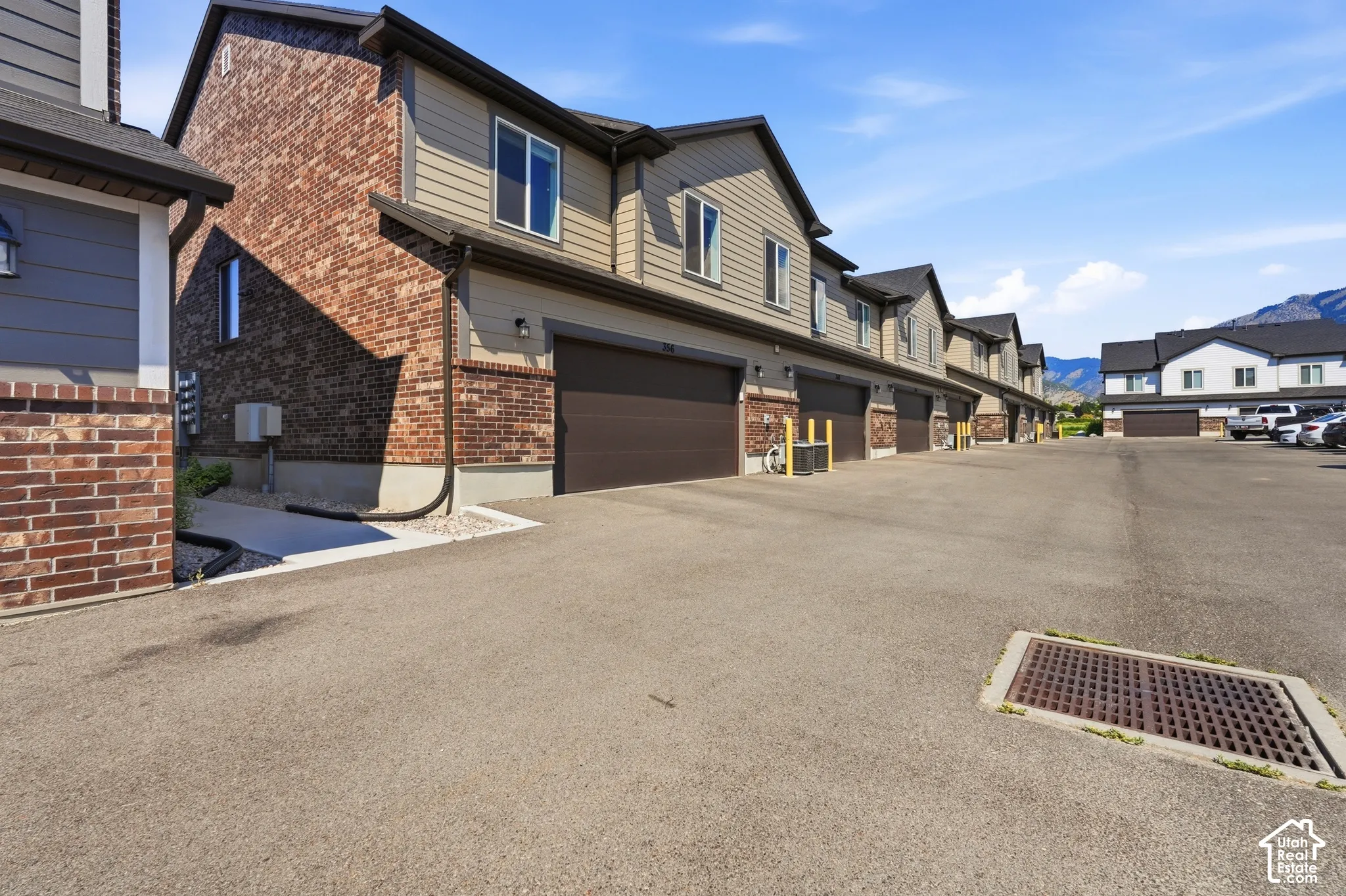 Townhome exterior featuring varied siding and brick accents