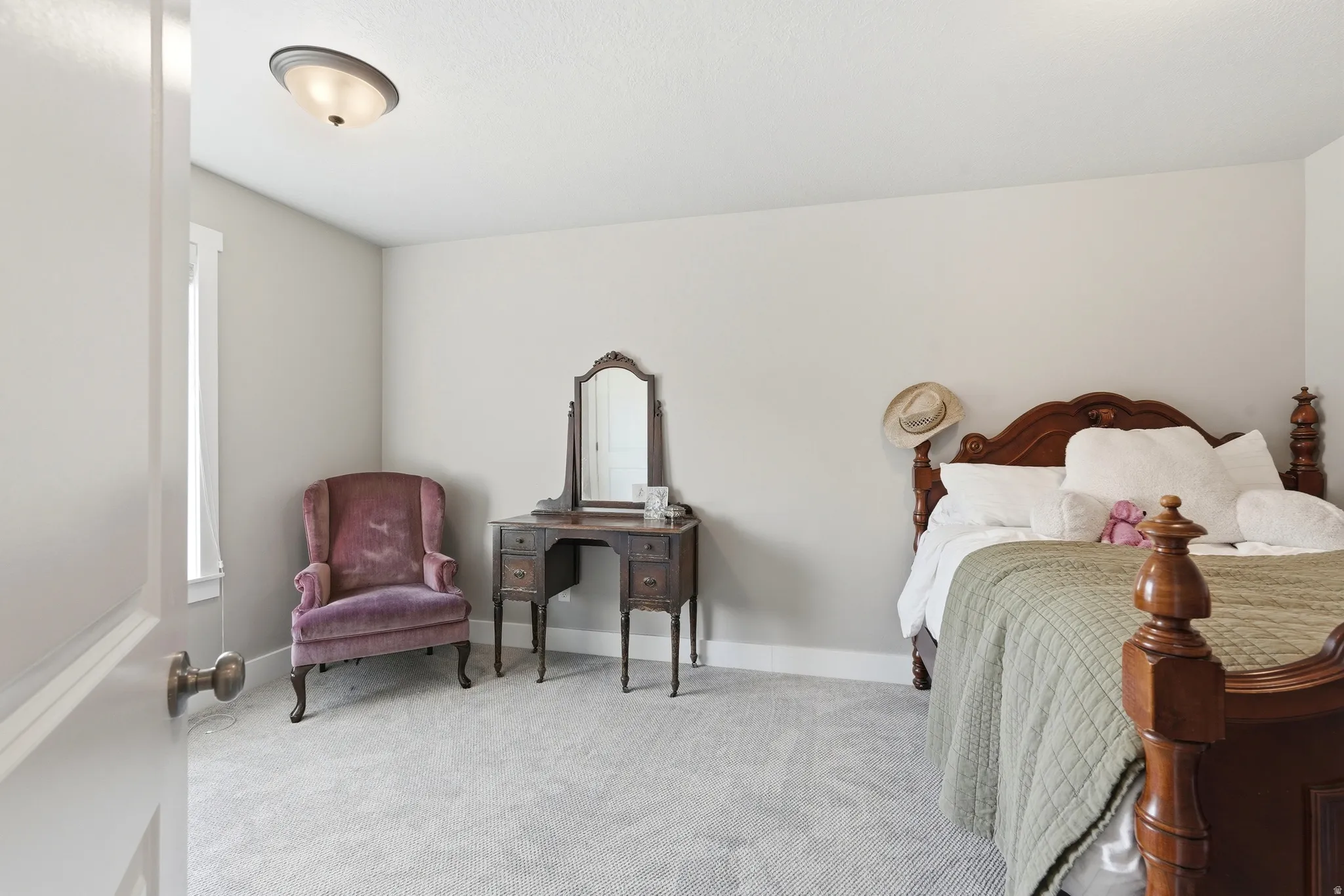 Neutral wall paint colors complement the light-toned carpeting