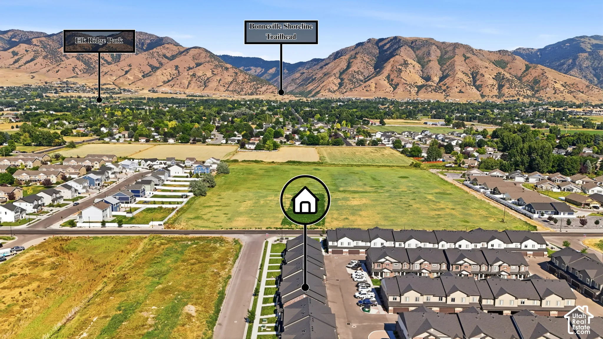 Aerial perspective showcasing a residential area with undeveloped land